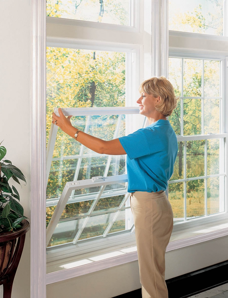 woman with replacement windows that tilt for easy cleaning